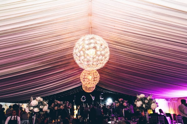 Hanging light decoration in wedding marquee