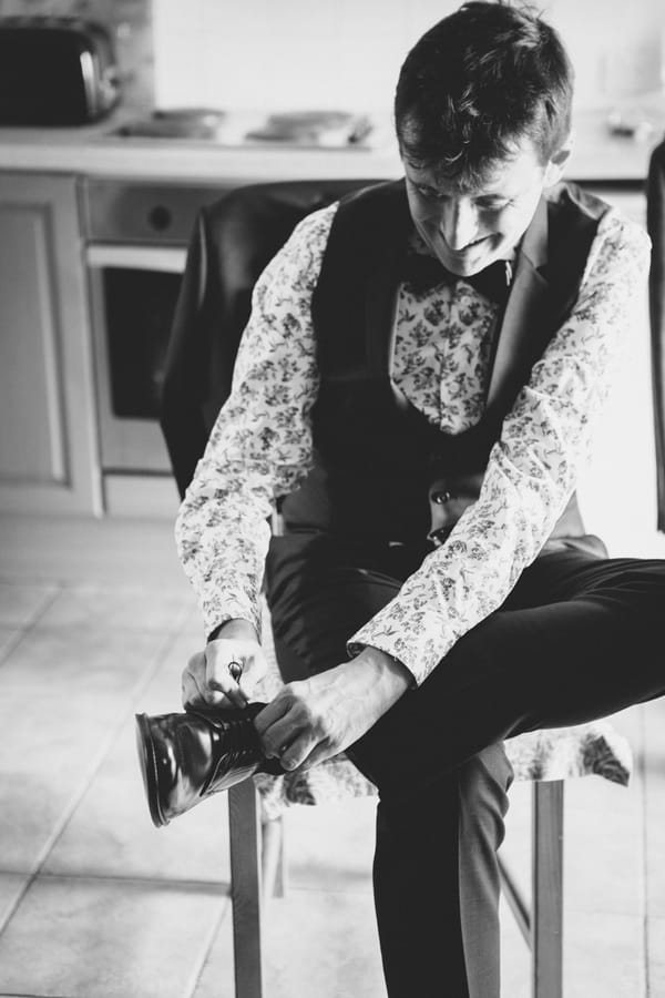 Groom putting on shoe