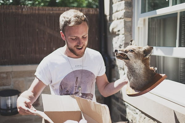 Man taking taxidermy out of box