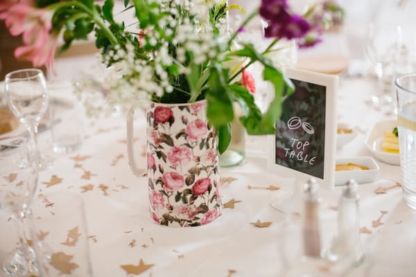 Floral jug on wedding table