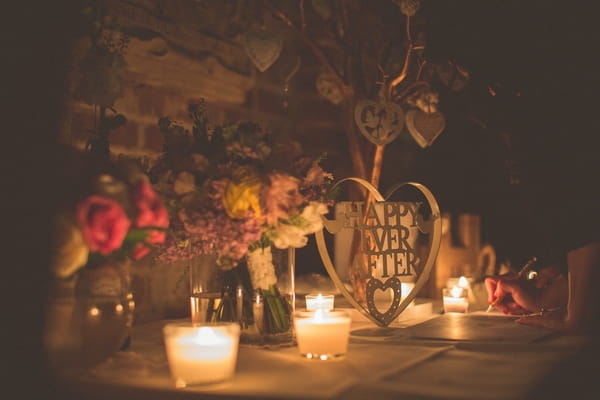 Wedding guest book table lit with candles