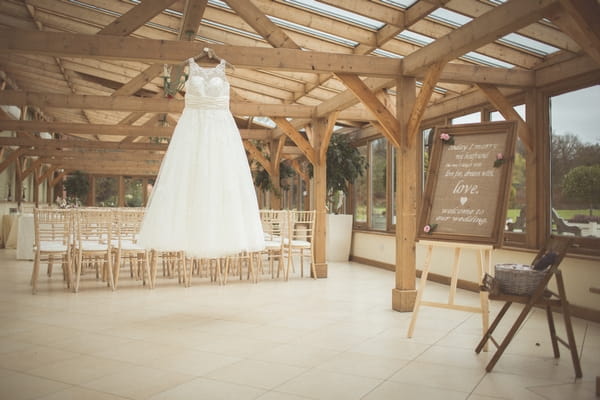 Wedding dress hanging in barn