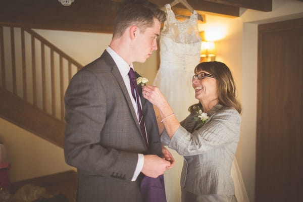 Man being helped with buttonhole