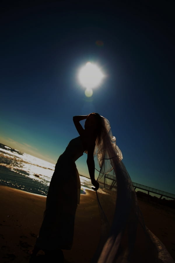 Silhouette of bride by sea in Venice