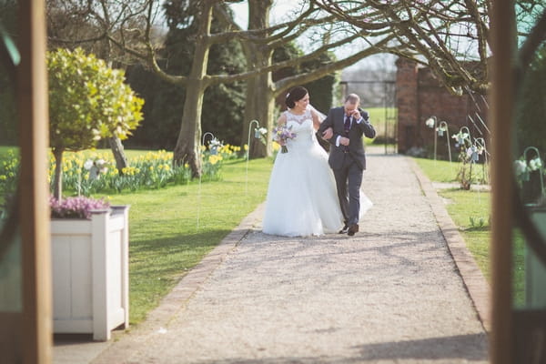 Bride walking to wedding ceremony with father