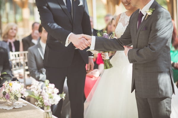 Father of bride shaking groom's hand