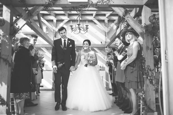 Bride and groom leave ceremony