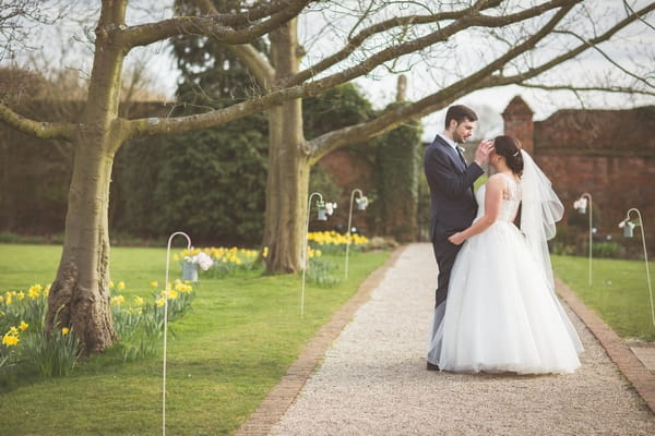 Bride and groom in gardens of Gaynes Park