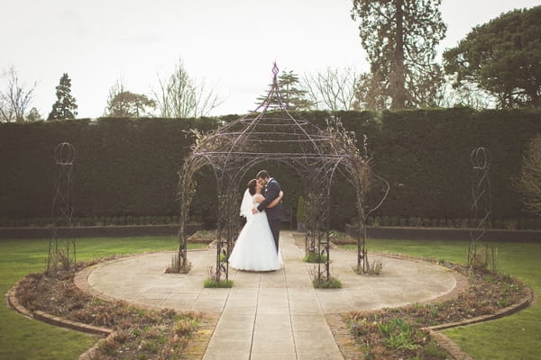 Bride and groom in gardens of Gaynes Park