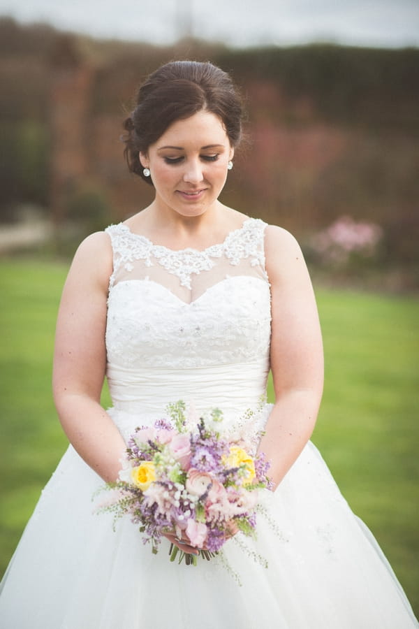 Bride looking at bouquet