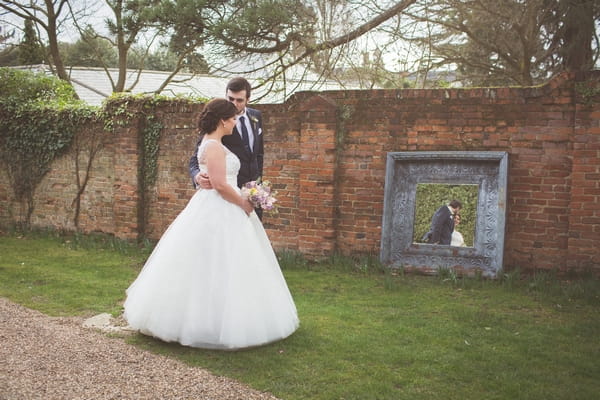 Bride and groom with reflection in mirror