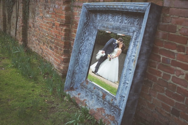 Bride and groom's reflection in mirror