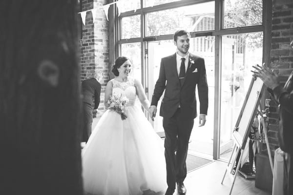 Bride and groom enter wedding breakfast