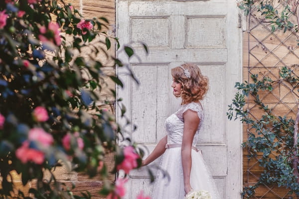 1950s bride standing by door