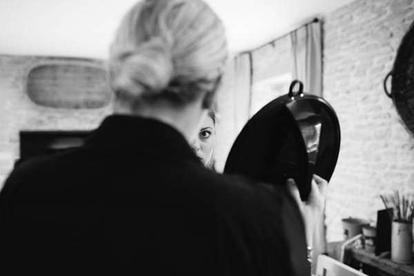 Bride looking in mirror