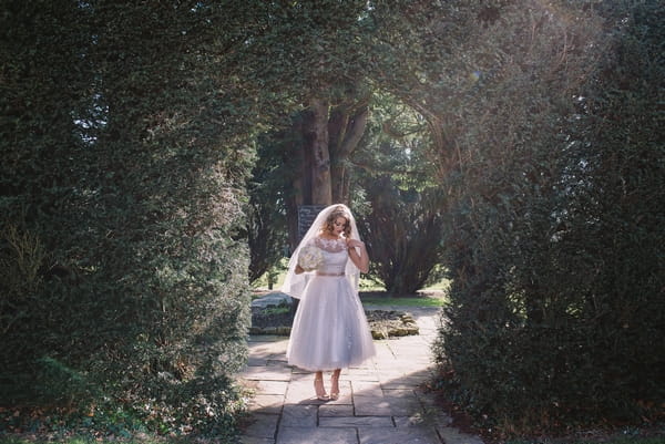 1950s bride walking through garden