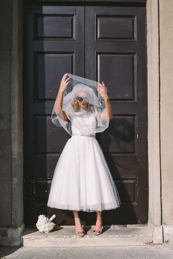 1950s bride lifting veil