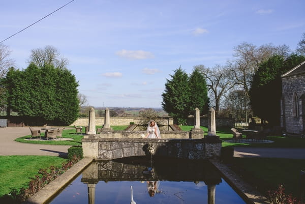 1950s bride in front of pond