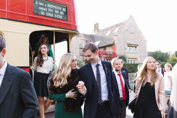 Wedding guests getting off bus