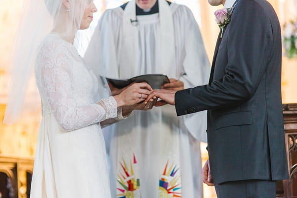 Bride and groom exchanging rings