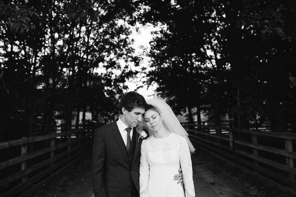 Bride and groom resting heads on each other