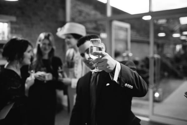 Wedding guest raising glass