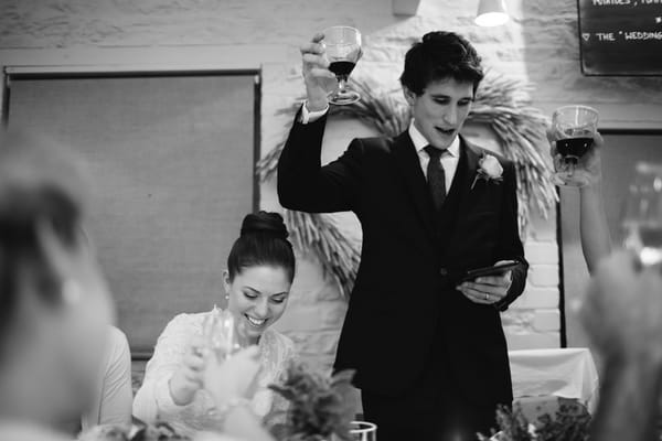 Groom raising glass for toast