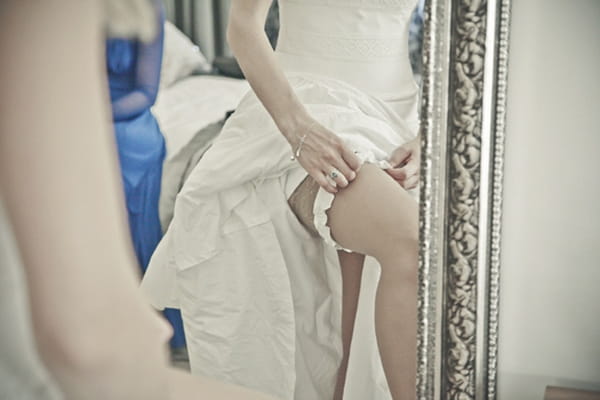 Bride putting on garter