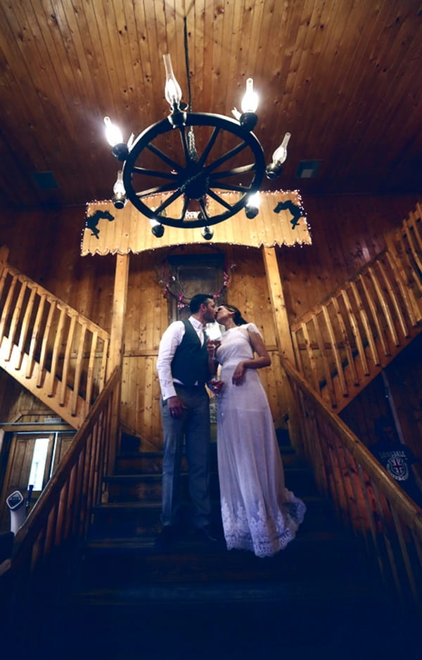 Bride and groom kiss on stairs