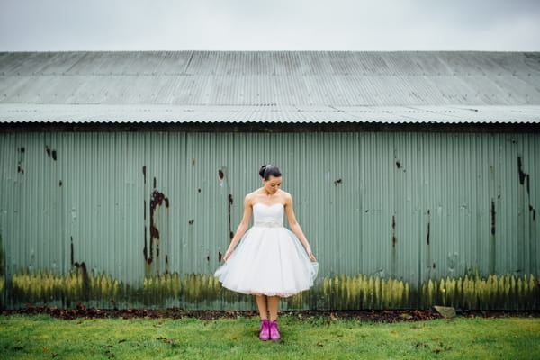 Bride holding out dress