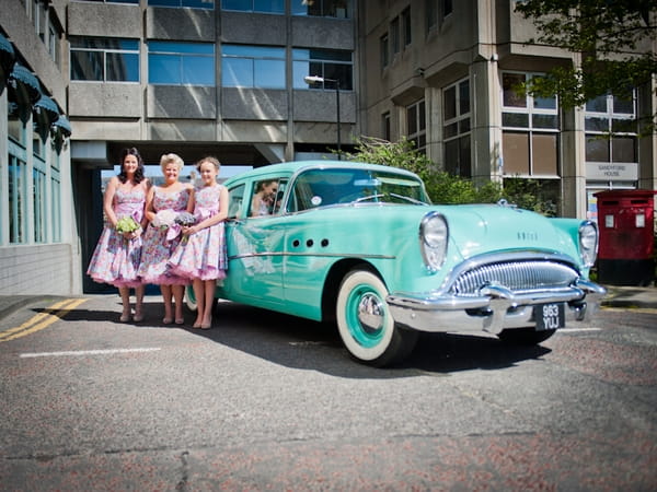 Bridesmaids next to wedding car