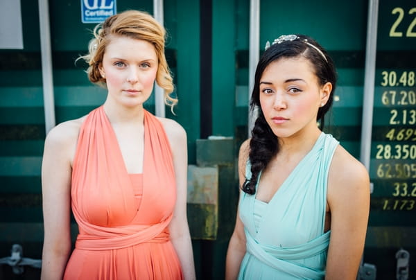 Bridesmaids in coral and blue dresses