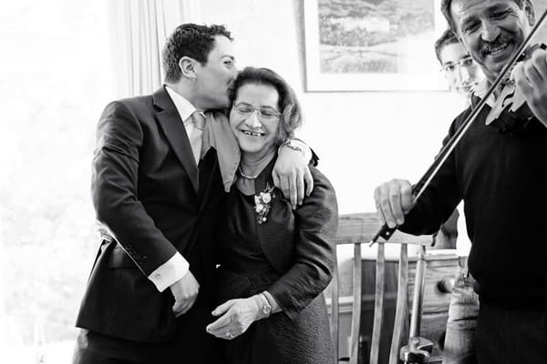 Groom kissing lady on head