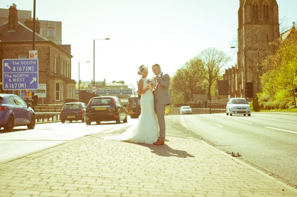 Bride and groom in middle of the road