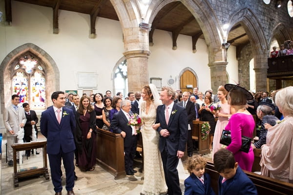 Bride walking down aisle with father