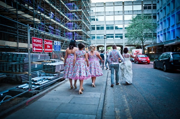 Bride and groom walking with bridesmaids