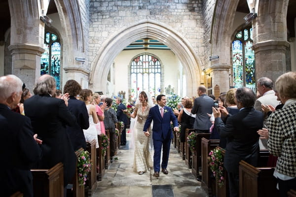 Bride and groom leaving wedding ceremony