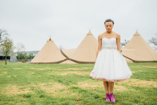 Bride standing in front of tipis