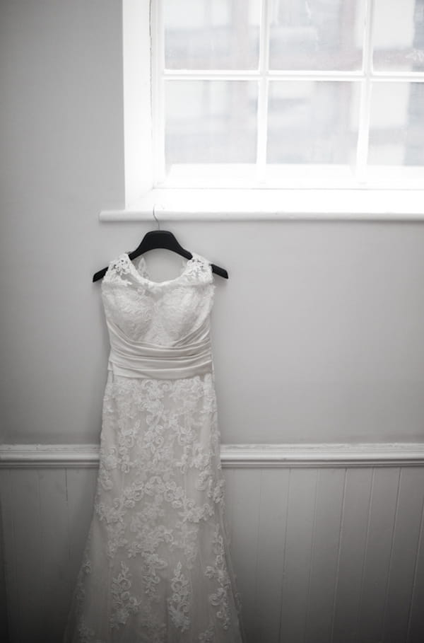 Wedding dress hanging on window ledge