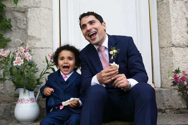 Young boy laughing with groom