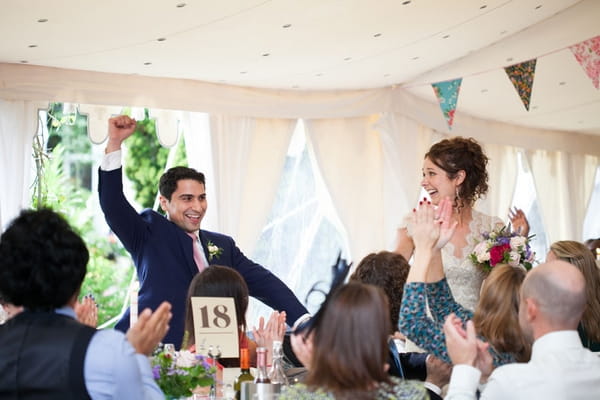 Groom punching the air as enters reception