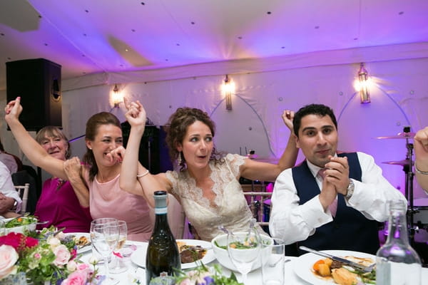 Bride and groom sitting in wedding reception