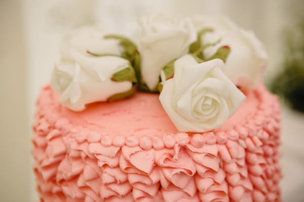 Flowers on top of pink wedding cake