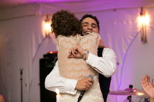 Bride and groom hug