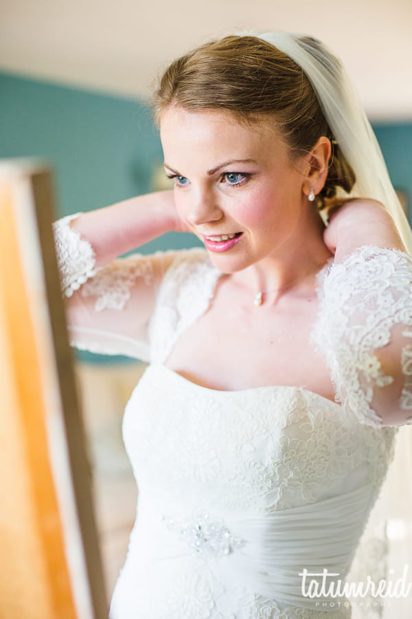 Bride looking in mirror