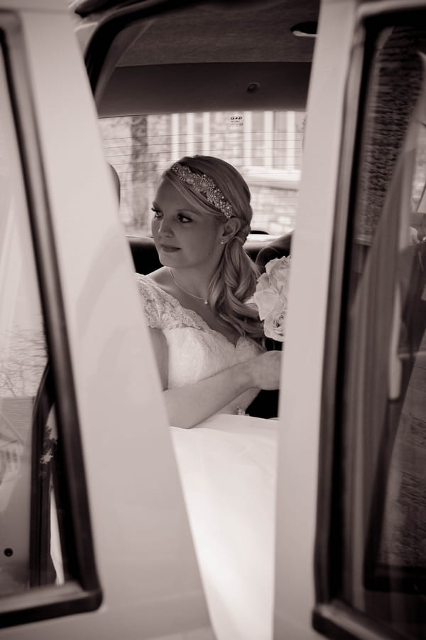 Bride in wedding car - Picture by Twirly Girl Photography