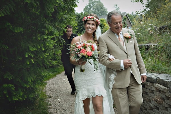 Father leading bride by arm