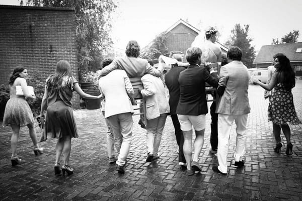 Bride and groom being carried