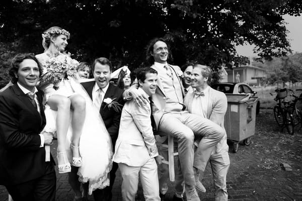 Bride and groom being carried