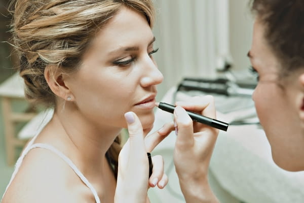 Bride having lip liner applied